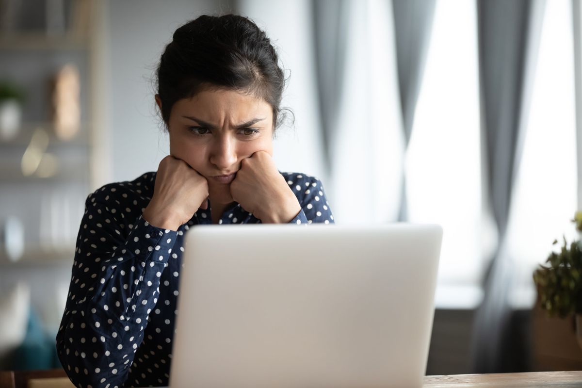 A frustrated marketer looking at a laptop